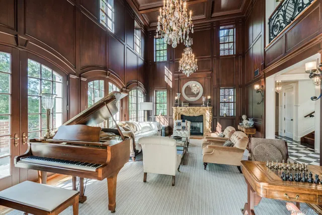 a living room with couches a dining table and chairs with wooden floor
