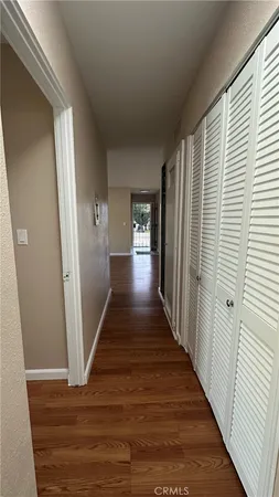 a view of a hallway with wooden floor