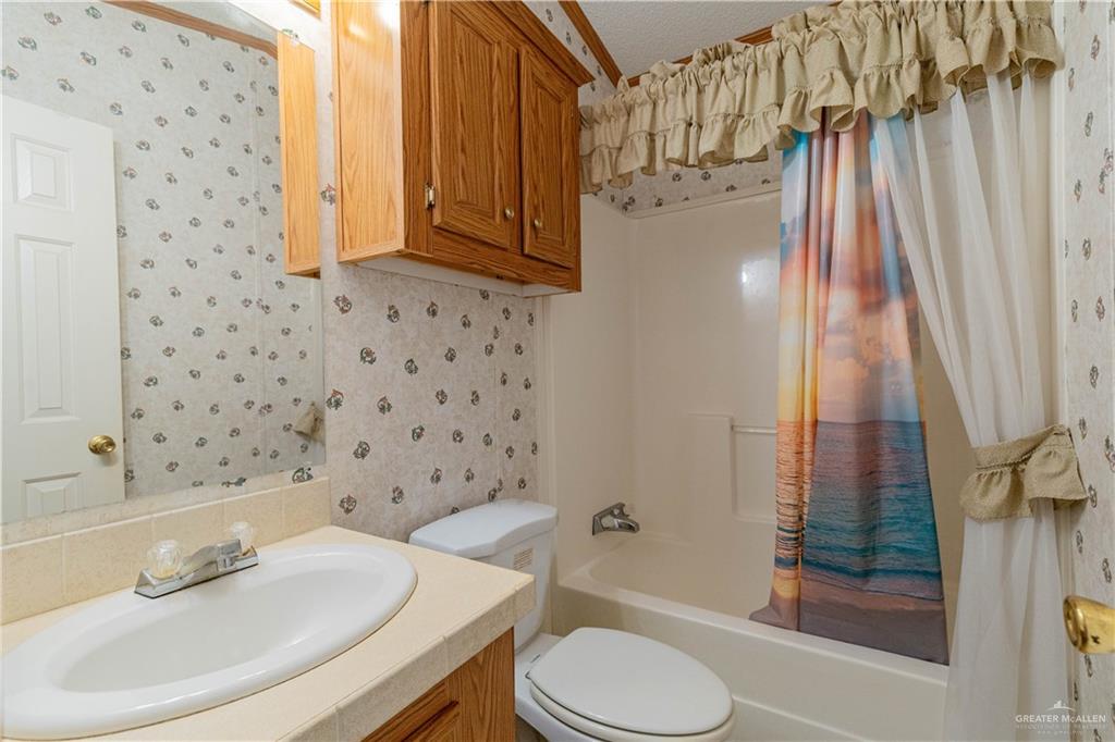 2004 Vernon Avenue Mission, TX 78572 - Photo 14 of 20 a bathroom with a sink toilet and shower