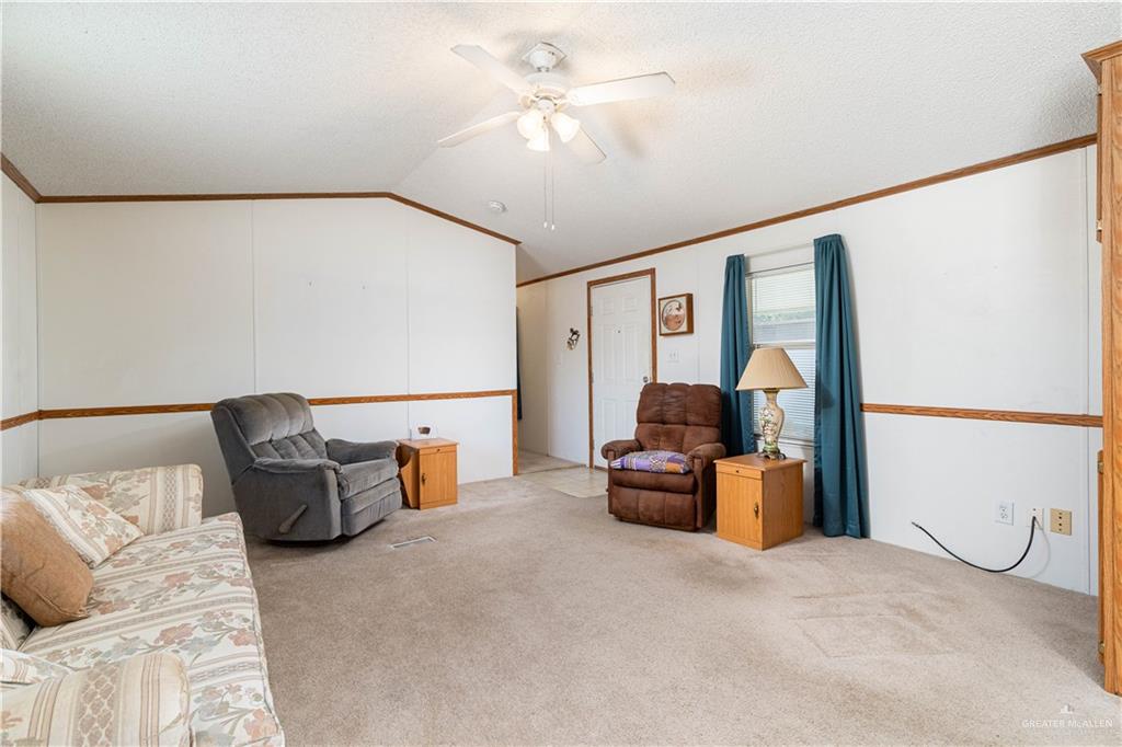 2004 Vernon Avenue Mission, TX 78572 - Photo 4 of 20 a living room with furniture and a chandelier