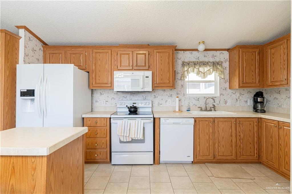 2004 Vernon Avenue Mission, TX 78572 - Photo 6 of 20 a kitchen with a refrigerator sink and cabinets