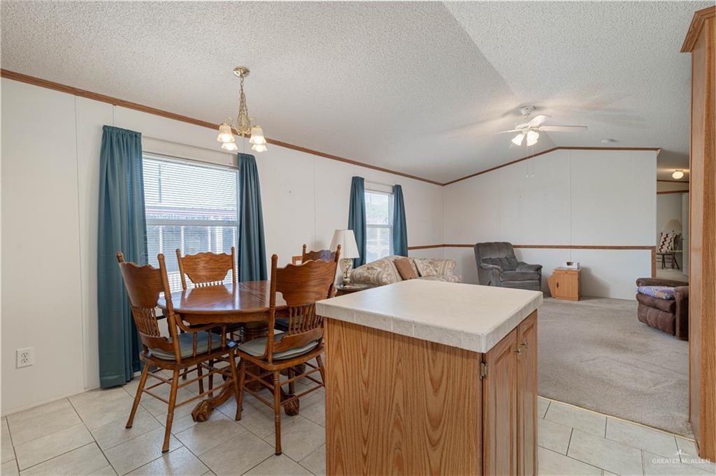 2004 Vernon Avenue Mission, TX 78572 - Photo 8 of 20 a view of a dining room with furniture and a chandelier