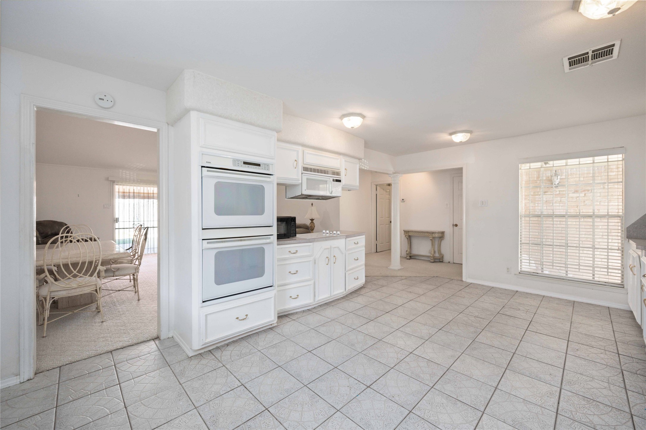 3910 Brookston Street Houston, TX 77045 - Photo 15 of 29 a kitchen with white cabinets and appliances