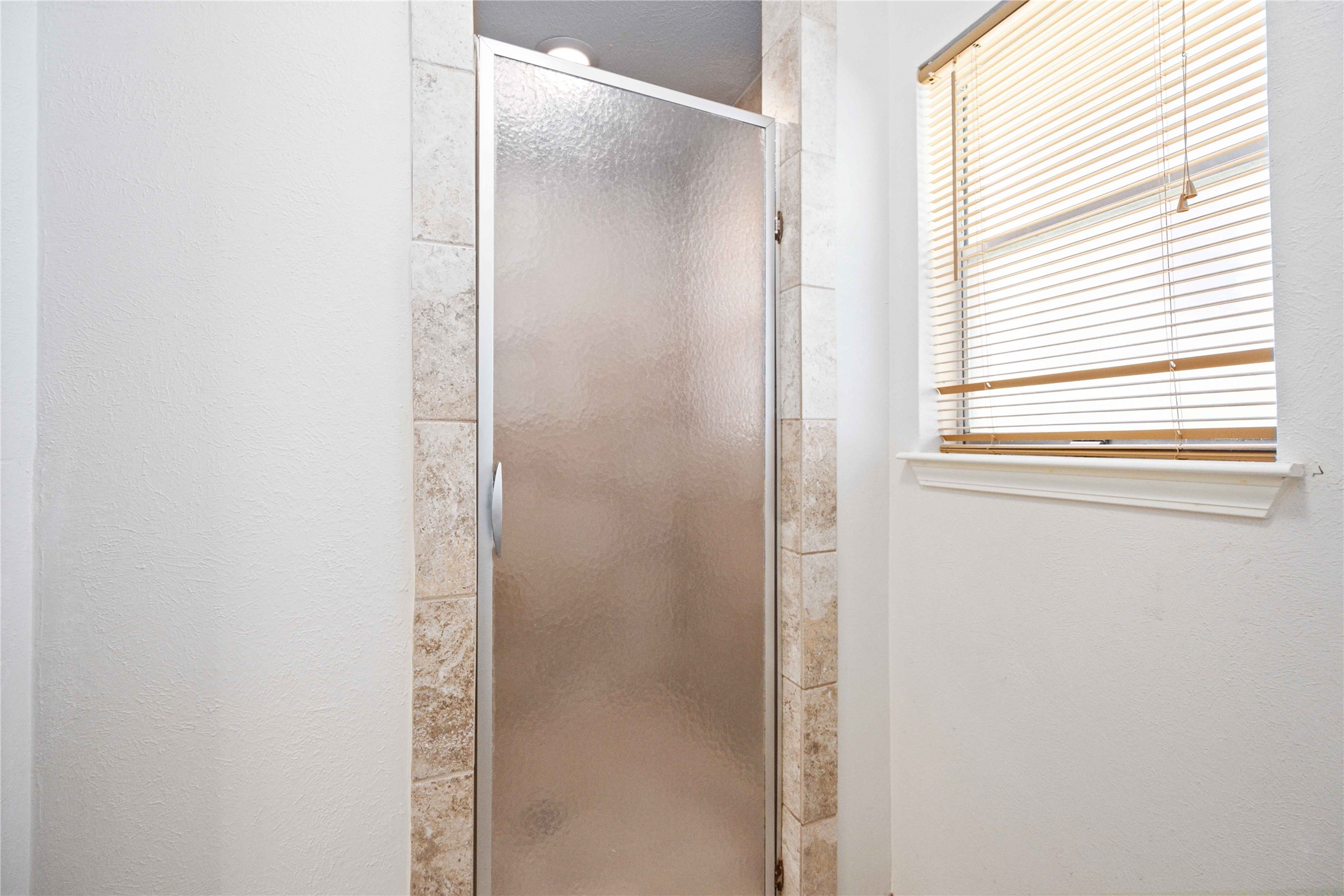 3910 Brookston Street Houston, TX 77045 - Photo 23 of 29 a bathroom with a glass shower door