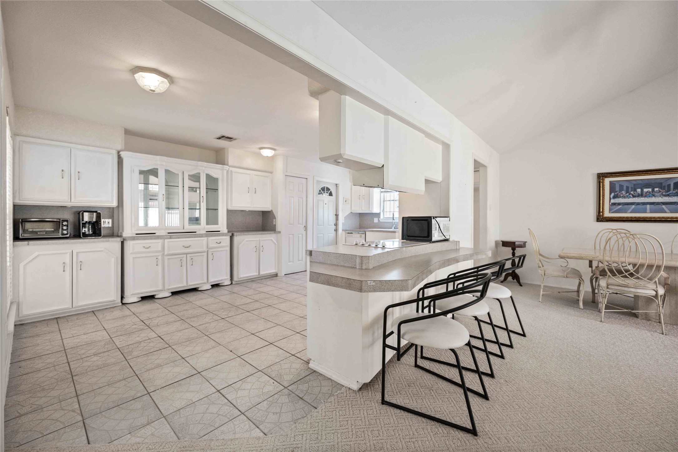 3910 Brookston Street Houston, TX 77045 - Photo 6 of 29 a kitchen with stainless steel appliances kitchen island granite countertop a stove top oven a sink a dining table and chairs with white cabinets