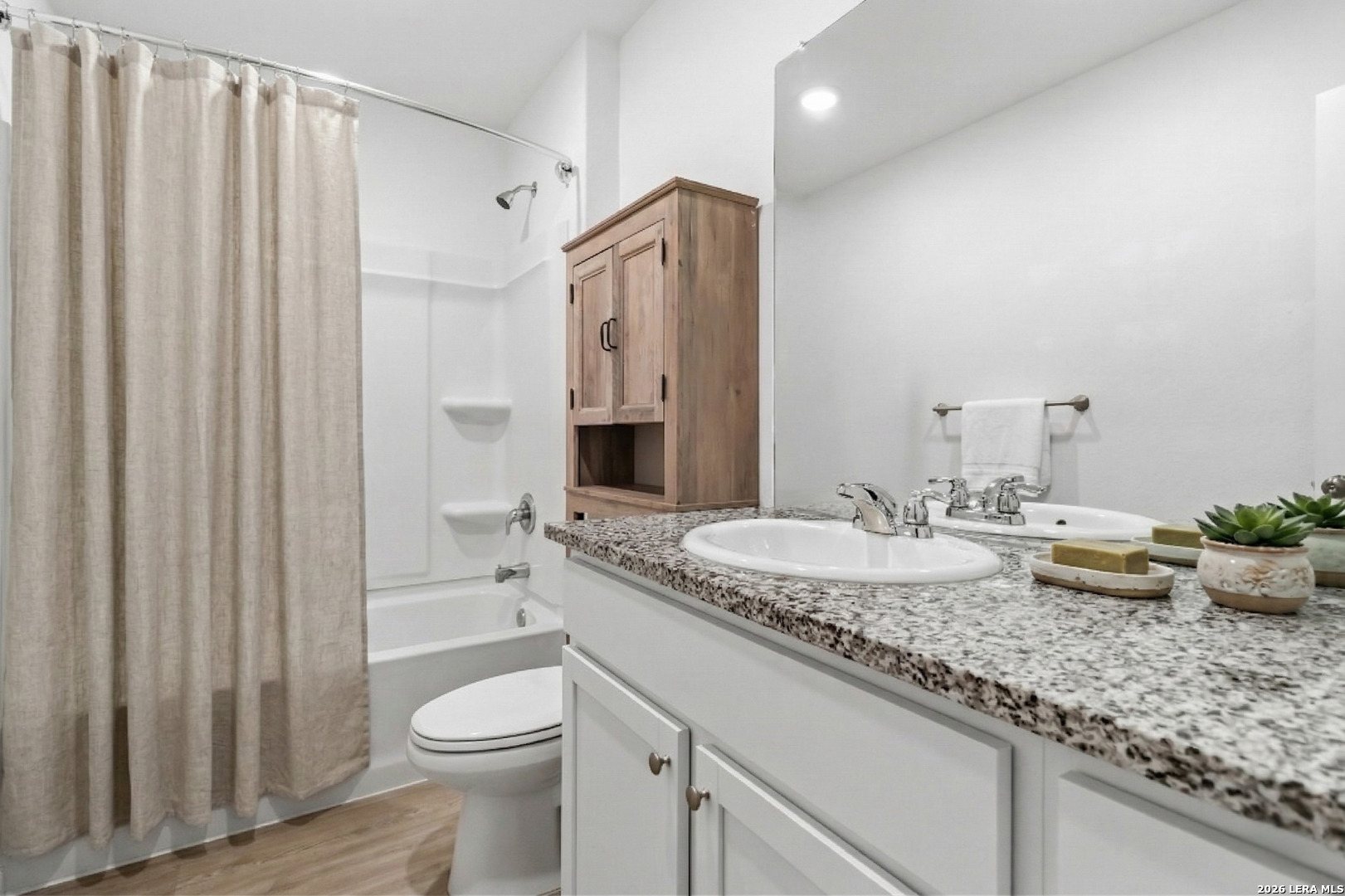 5155 Fowler Crest Converse, TX 78109 - Photo 13 of 20 a bathroom with a granite countertop sink and a mirror