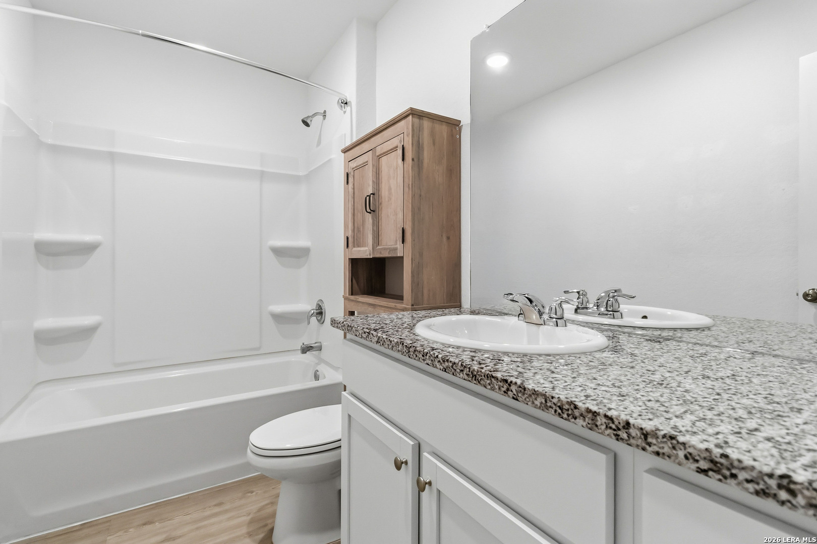 5155 Fowler Crest Converse, TX 78109 - Photo 14 of 20 a bathroom with a granite countertop sink toilet and shower