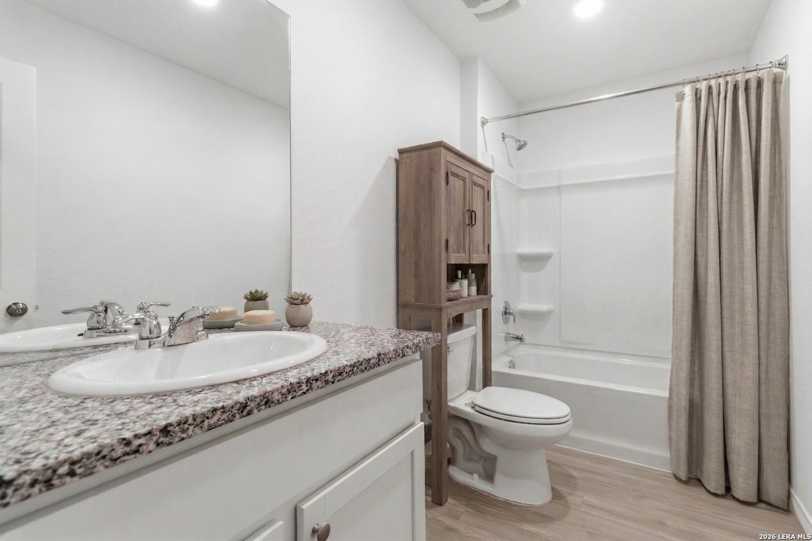 5155 Fowler Crest Converse, TX 78109 - Photo 17 of 20 a bathroom with a granite countertop sink toilet a shower and a mirror