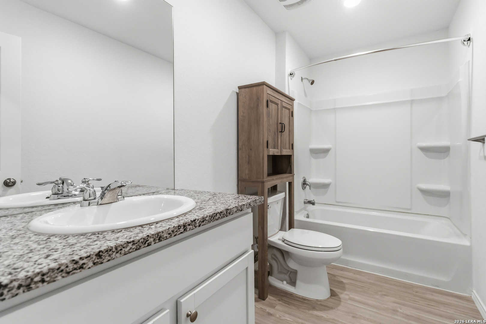 5155 Fowler Crest Converse, TX 78109 - Photo 18 of 20 a bathroom with a granite countertop sink toilet mirror and shower