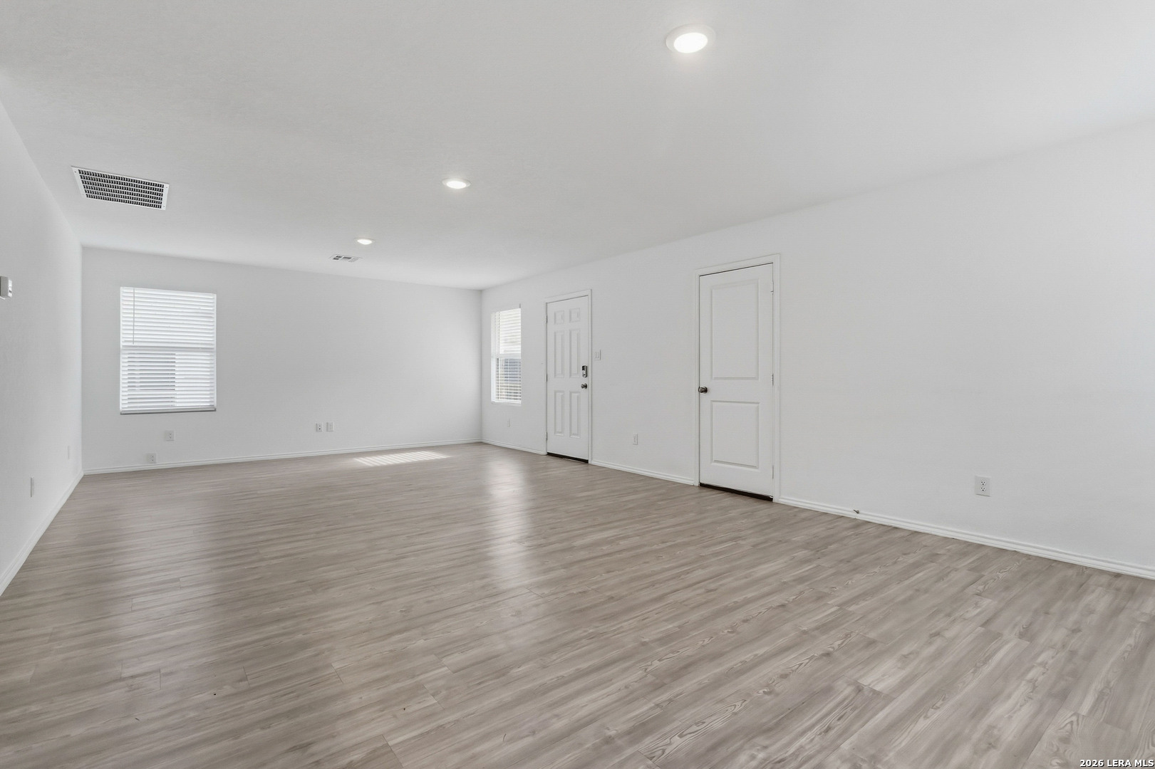 5155 Fowler Crest Converse, TX 78109 - Photo 6 of 20 a view of an empty room with wooden floor and a window