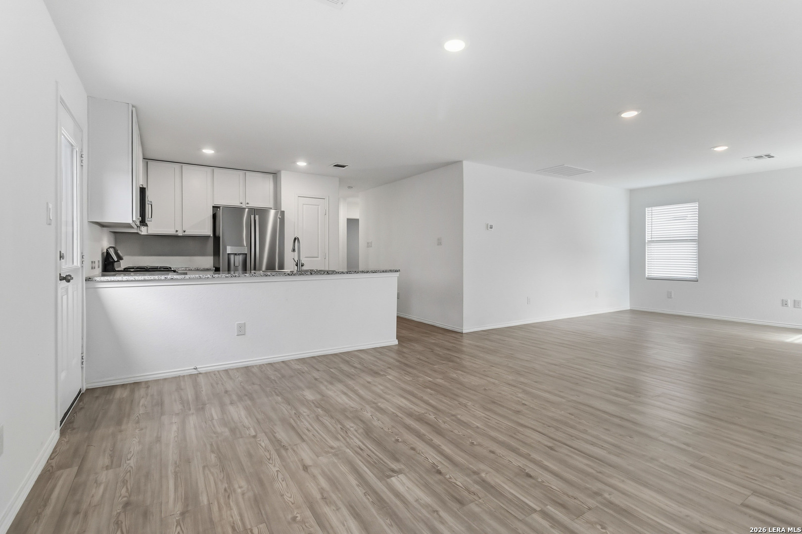5155 Fowler Crest Converse, TX 78109 - Photo 7 of 20 a view of a kitchen with kitchen island wooden floor center island and stainless steel appliances