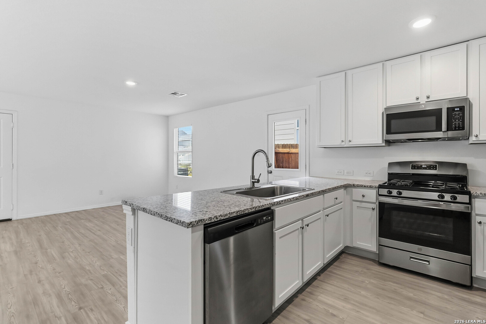 5155 Fowler Crest Converse, TX 78109 - Photo 9 of 20 a kitchen with granite countertop a sink and steel appliances