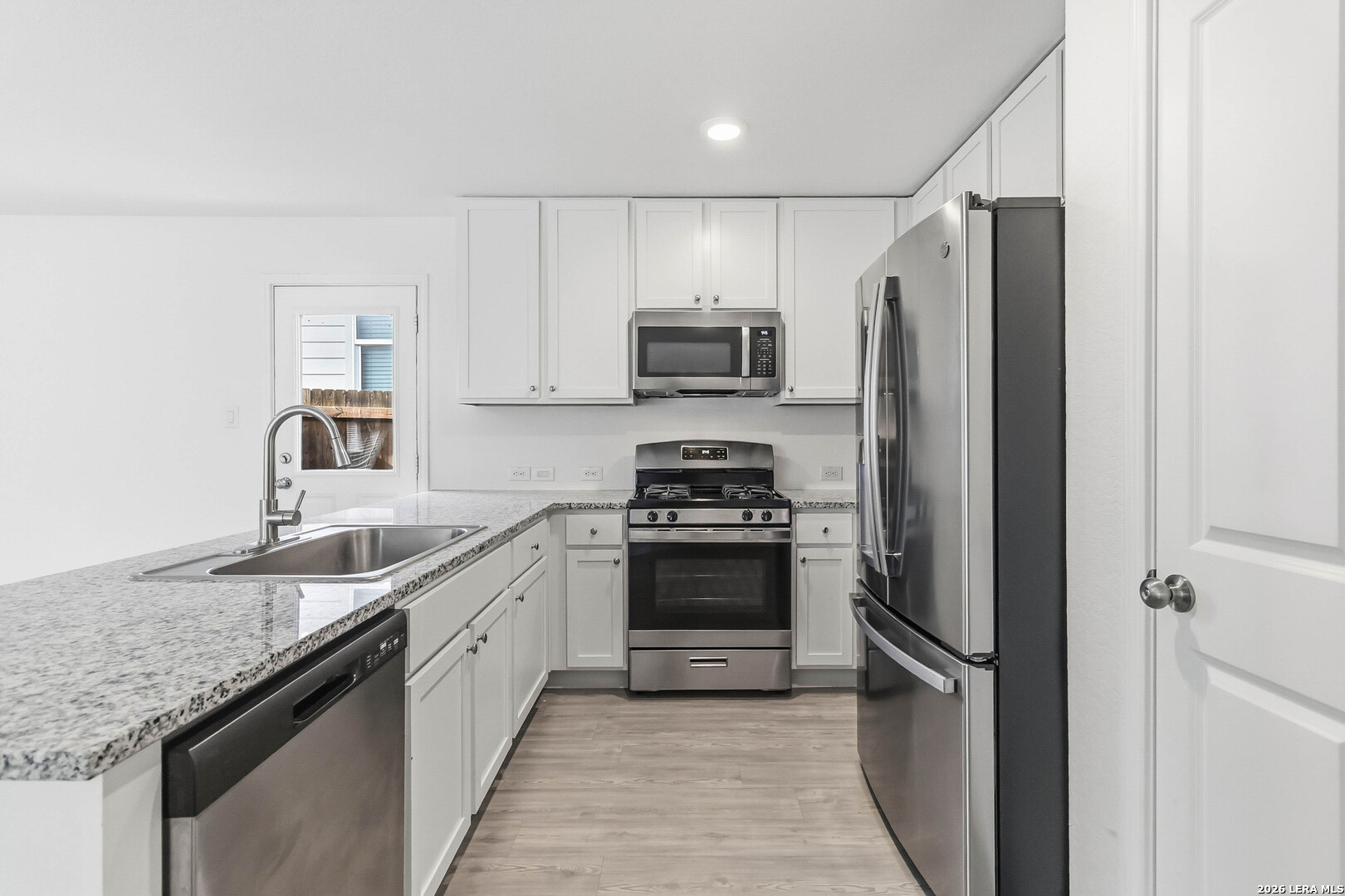 5155 Fowler Crest Converse, TX 78109 - Photo 10 of 20 a kitchen with stainless steel appliances granite countertop a refrigerator a sink and a stove