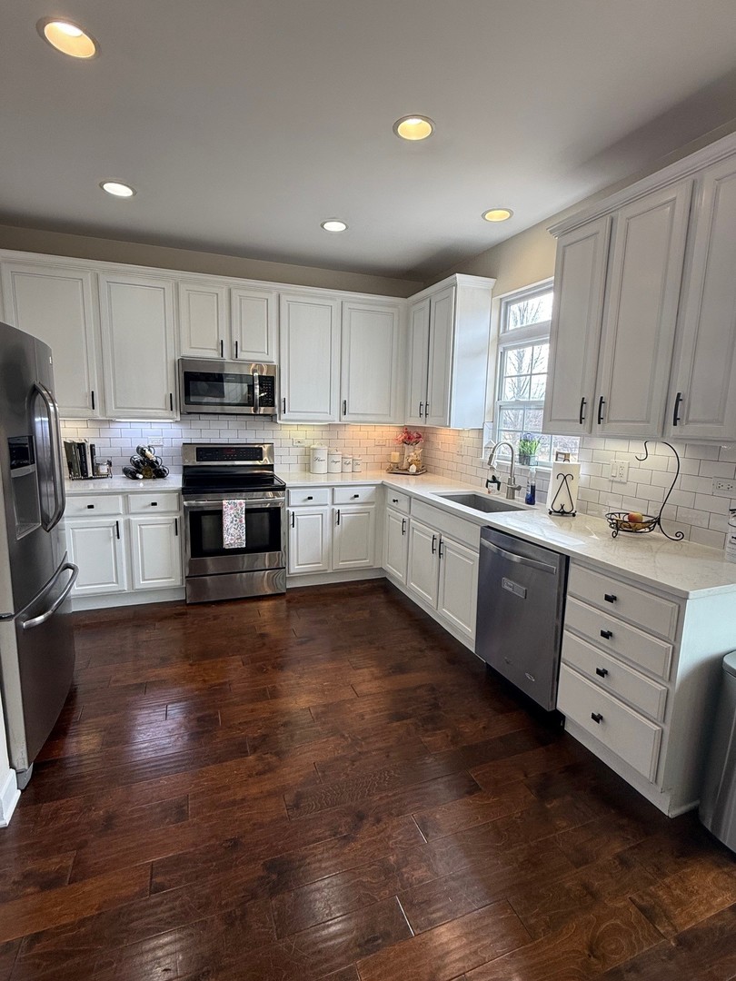 1785 Briggs Street Sycamore, IL 60178 - Photo 11 of 43 a kitchen with kitchen island granite countertop a sink cabinets and stainless steel appliances