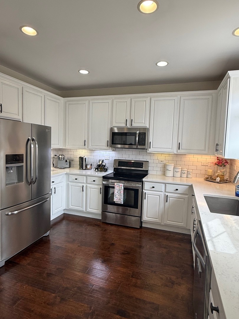 1785 Briggs Street Sycamore, IL 60178 - Photo 12 of 43 a kitchen with granite countertop white cabinets and stainless steel appliances