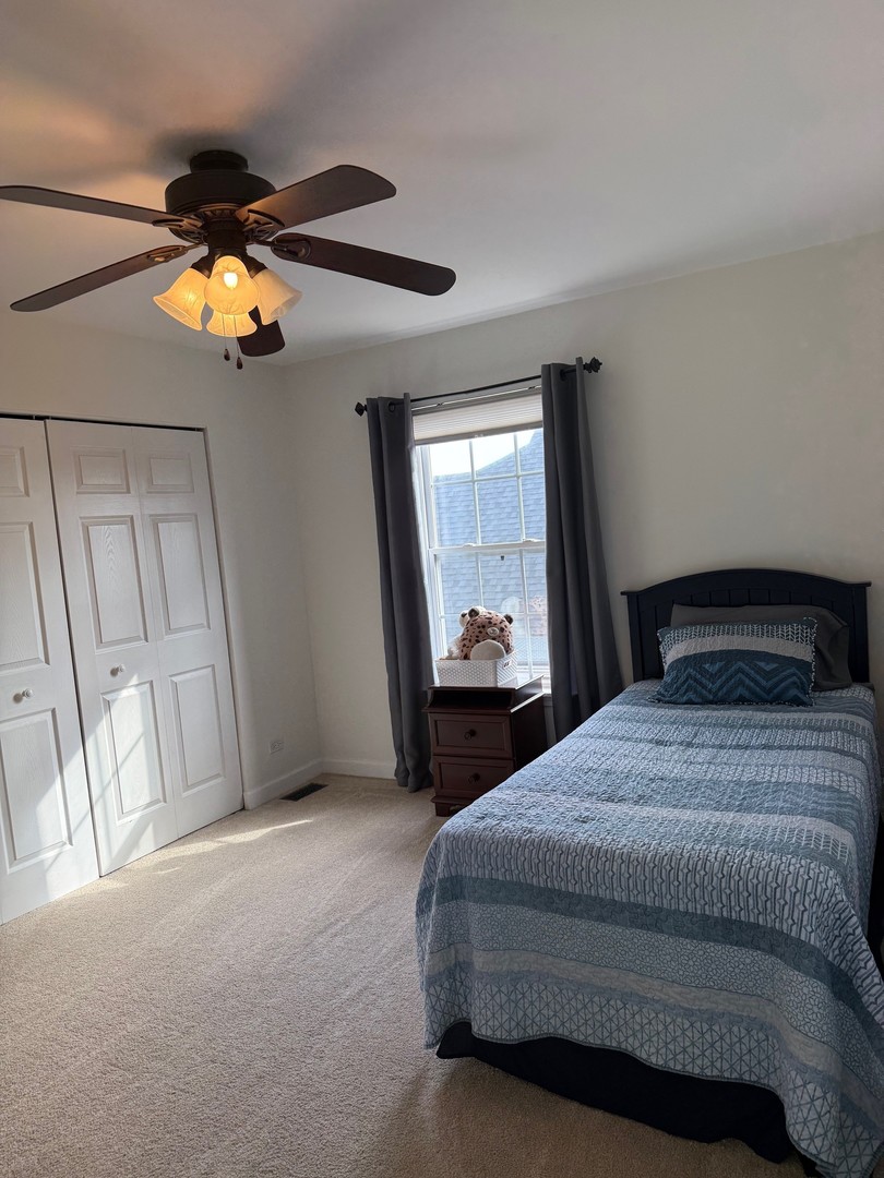 1785 Briggs Street Sycamore, IL 60178 - Photo 29 of 43 a bedroom with a bed and a chandelier