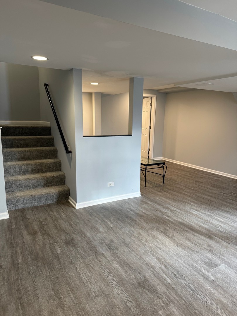 1785 Briggs Street Sycamore, IL 60178 - Photo 30 of 43 a view of an empty room with wooden floor and stairs