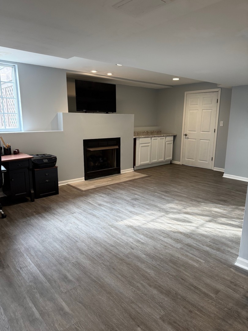 1785 Briggs Street Sycamore, IL 60178 - Photo 35 of 43 an empty room with wooden floor fireplace and windows