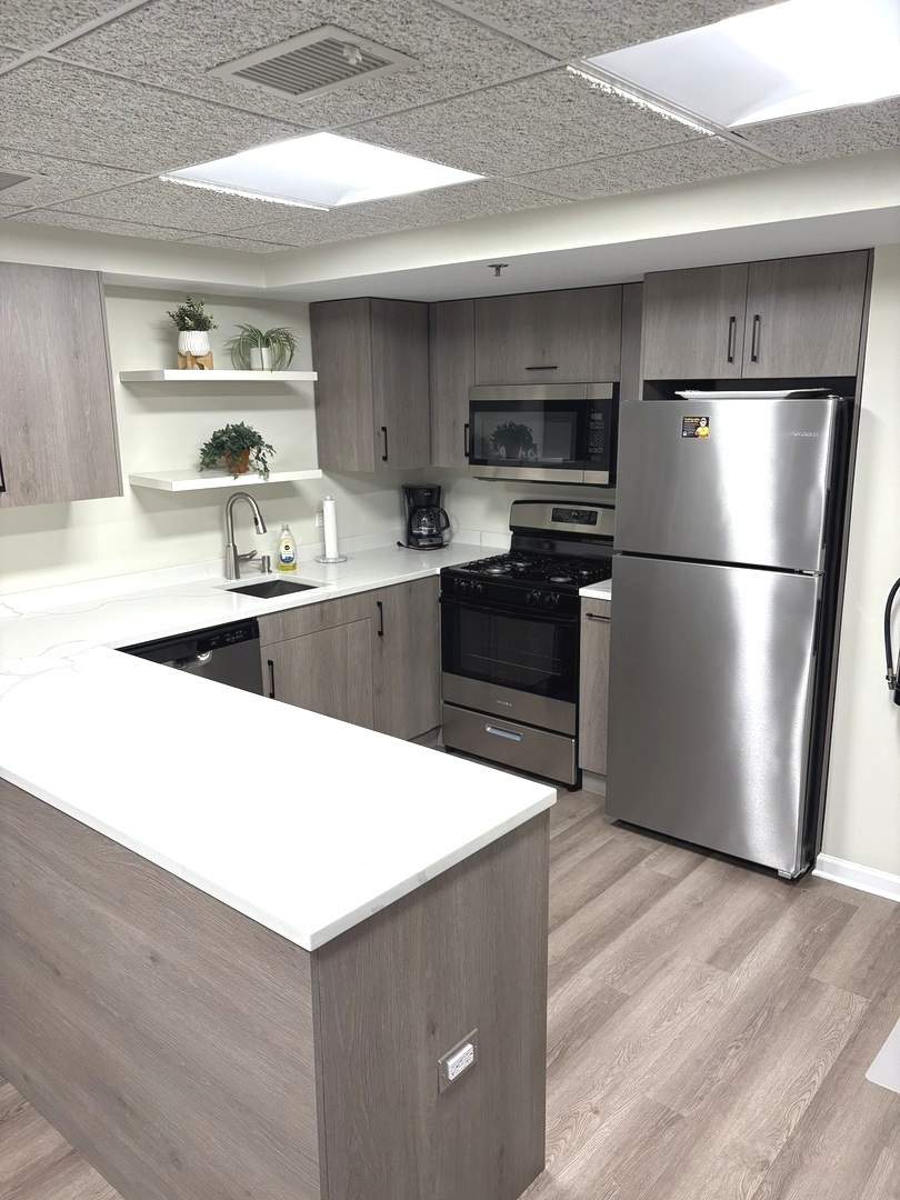 1220 Depot Street, Unit 305 Glenview, IL 60025 - Photo 22 of 28 a kitchen with stainless steel appliances a refrigerator a stove a sink and white cabinets