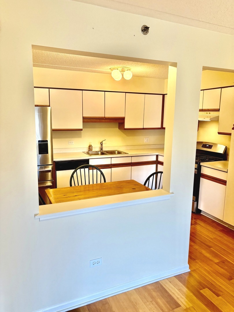 1220 Depot Street, Unit 305 Glenview, IL 60025 - Photo 8 of 28 a view of a room with wooden floor