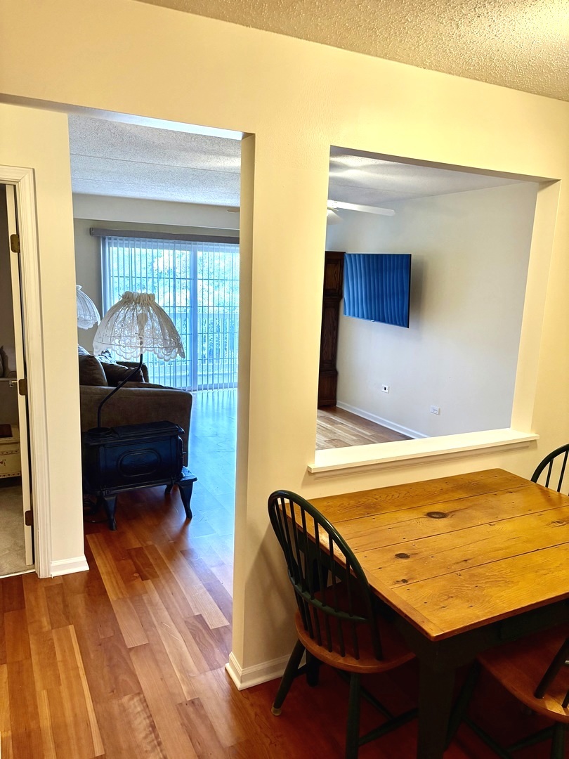 1220 Depot Street, Unit 305 Glenview, IL 60025 - Photo 9 of 28 a room with furniture and a wooden floor