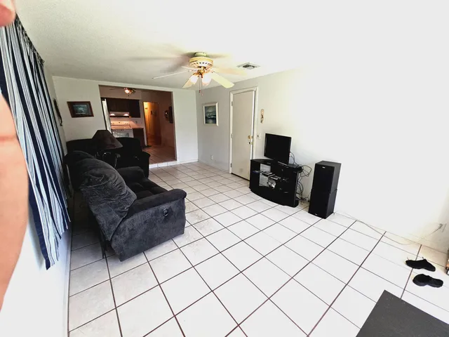 a living room with dining room and wooden floor