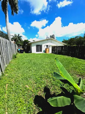 a pathway of a house with a yard