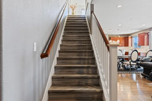 a view of entryway and hall with wooden floor