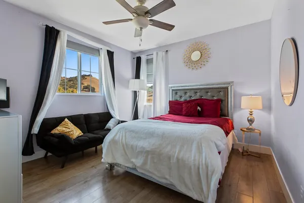 a bedroom with a bed and a chandelier