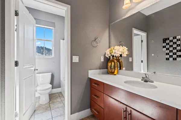 a bathroom with a toilet a sink and a mirror