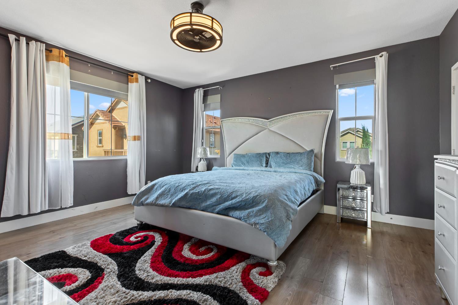 9423 Vintner Circle Patterson, CA 95363 - Photo 20 of 33 a bedroom with a bed and a chandelier