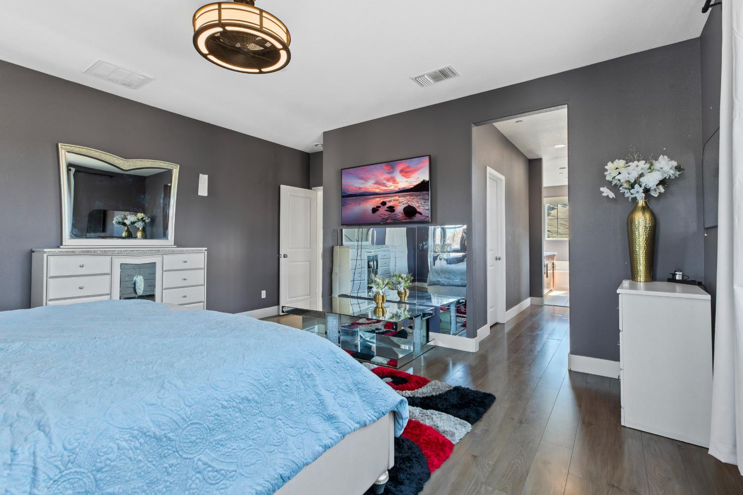 9423 Vintner Circle Patterson, CA 95363 - Photo 21 of 33 a bedroom with furniture and a chandelier