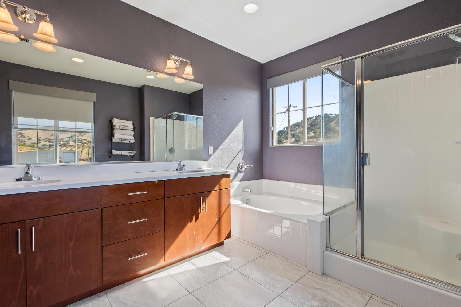 9423 Vintner Circle Patterson, CA 95363 - Photo 23 of 33 a spacious bathroom with a tub sink and mirror