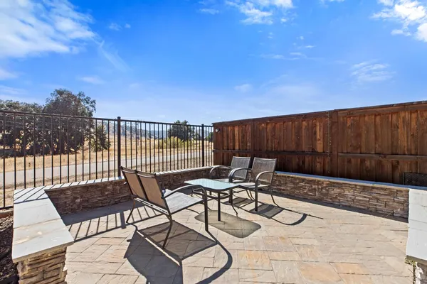 a view of a chairs and table in the patio