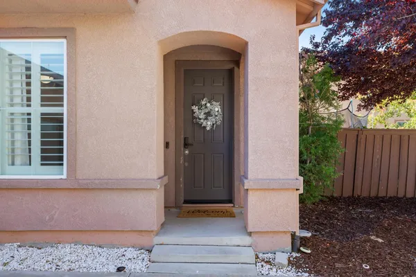 a front view of a house with a garden
