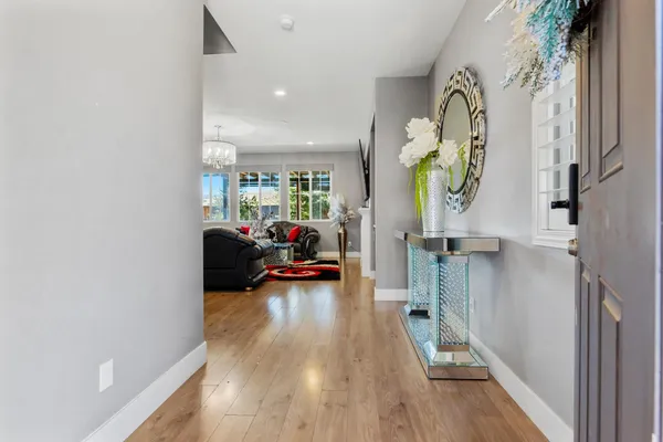 a living room with furniture and a wooden floor