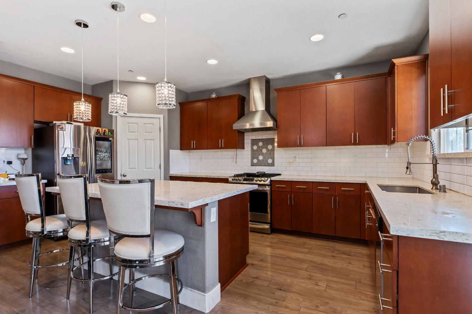 9423 Vintner Circle Patterson, CA 95363 - Photo 5 of 33 a kitchen with a sink cabinets and wooden floor