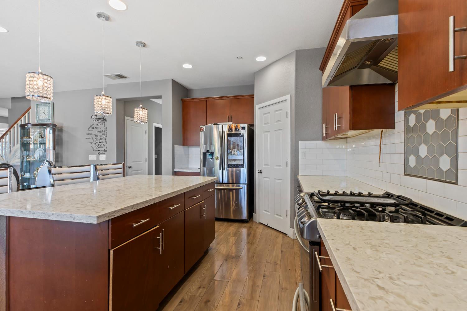 9423 Vintner Circle Patterson, CA 95363 - Photo 6 of 33 a kitchen with a sink stove and refrigerator