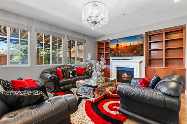 a living room with furniture a fireplace and a flat screen tv