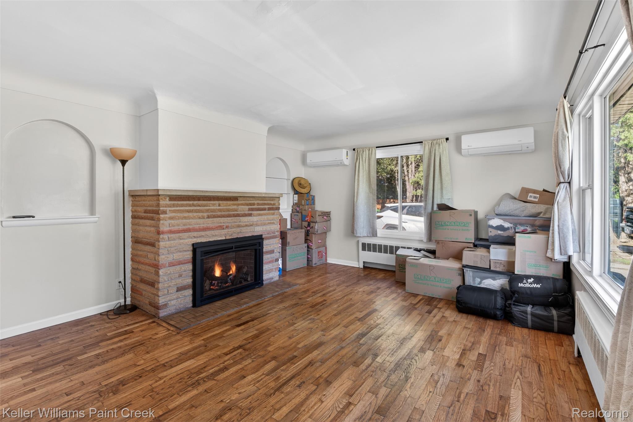 2942 Tatham Road Saginaw, MI 48601 - Photo 7 of 59 Living room with wood-type flooring, a fireplace, and a wall mounted mini split