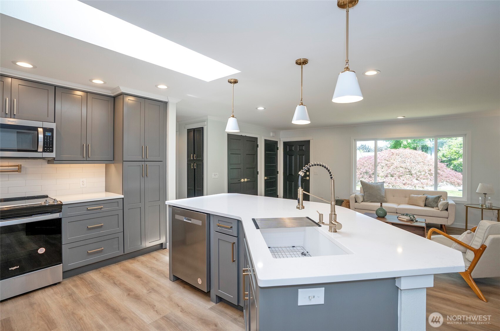 15512 Elm Street East Sumner, WA 98390 - Photo 13 of 37 a kitchen with stainless steel appliances granite countertop a sink a stove a refrigerator and island with wooden floor