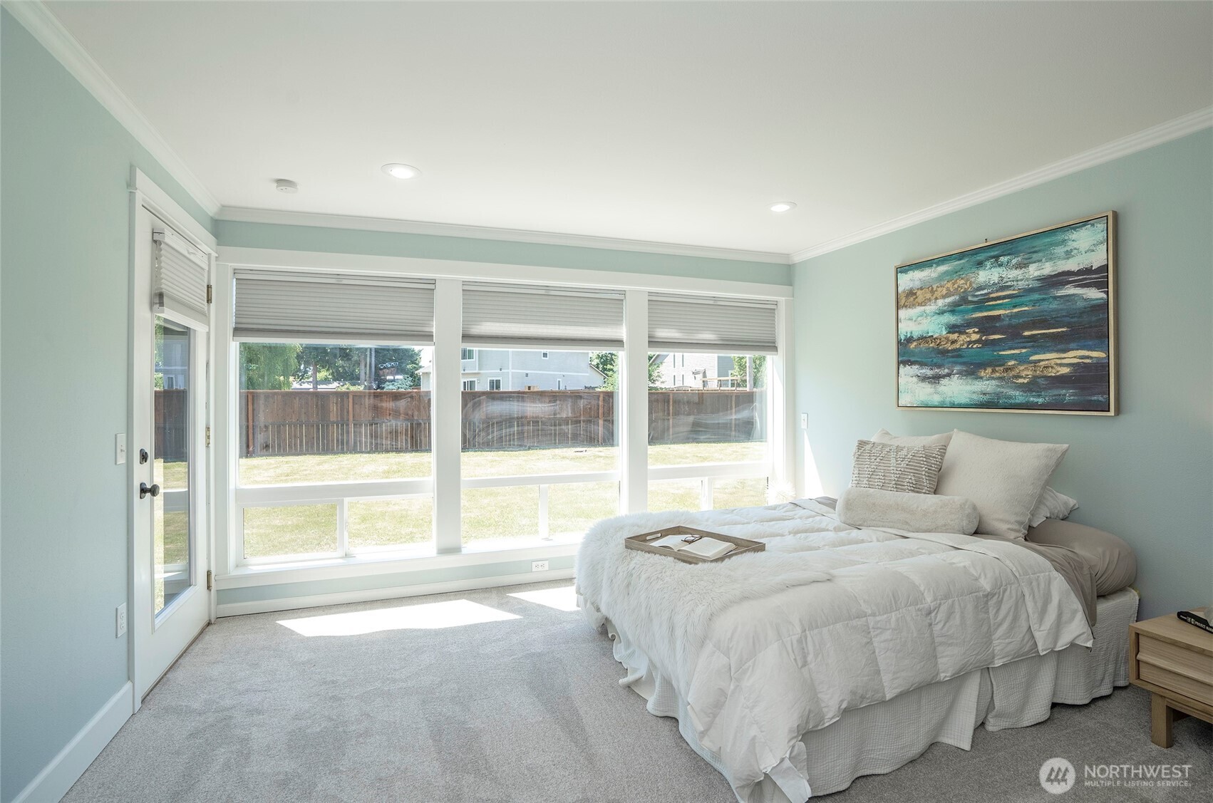 15512 Elm Street East Sumner, WA 98390 - Photo 15 of 37 a spacious bedroom with a large bed and a large window