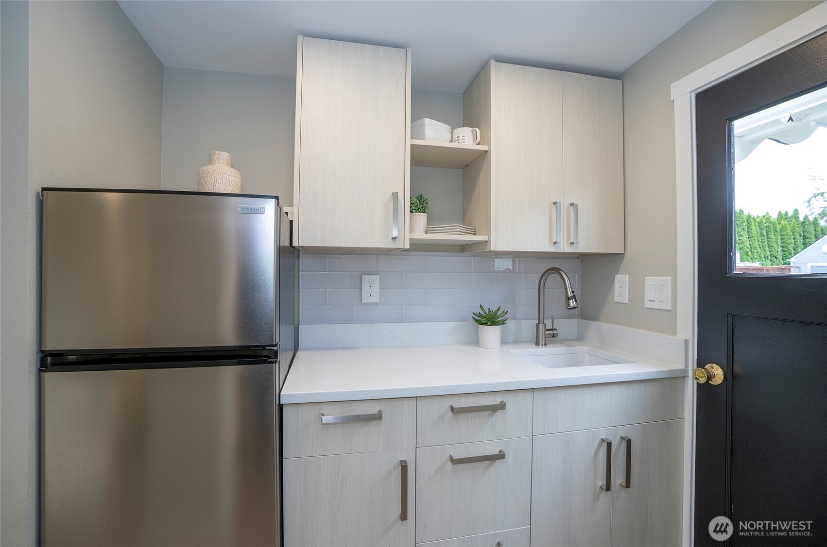 15512 Elm Street East Sumner, WA 98390 - Photo 26 of 37 a kitchen with a sink and a refrigerator