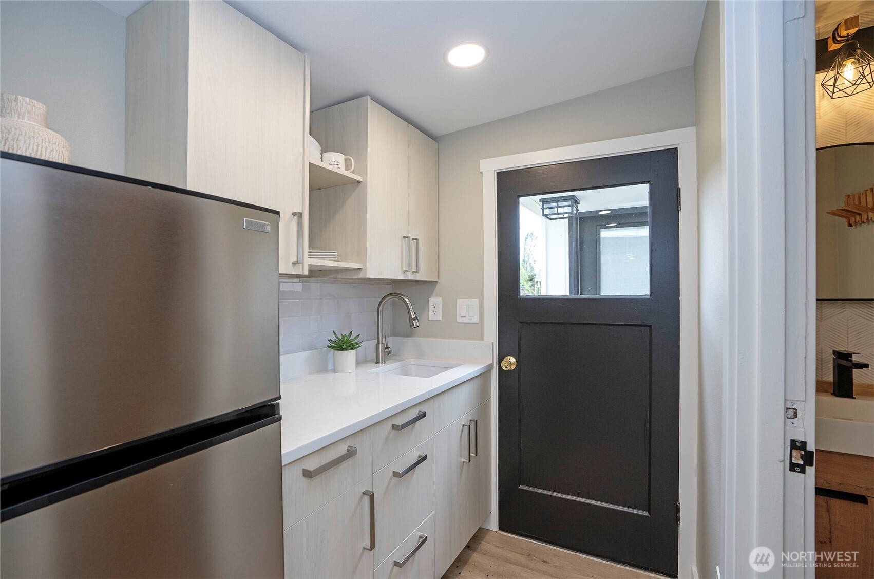 15512 Elm Street East Sumner, WA 98390 - Photo 29 of 37 a kitchen with a sink cabinets and a refrigerator