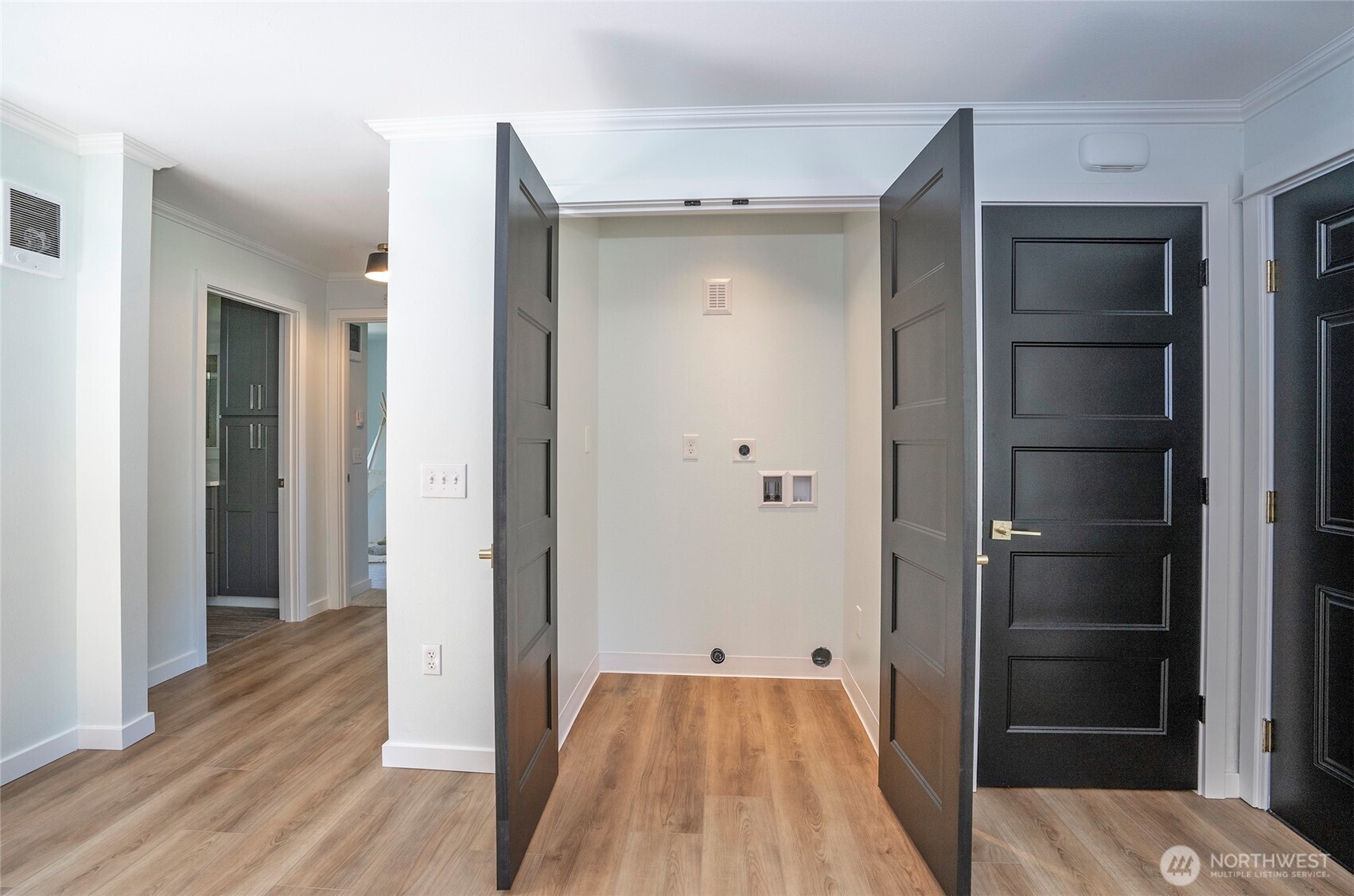 15512 Elm Street East Sumner, WA 98390 - Photo 8 of 37 a view of a hallway with wooden floor and closet area