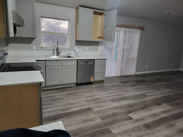 a kitchen with a sink stove and cabinets