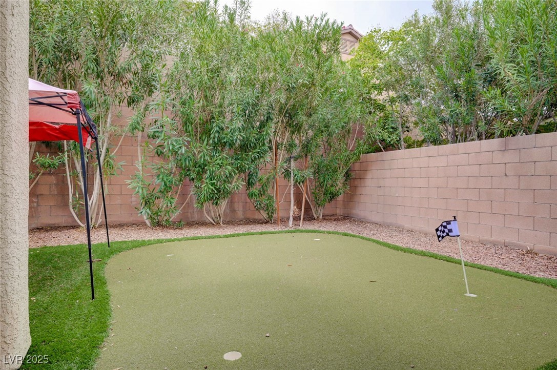 23 Lily Grove Road Las Vegas, NV 89148 - Photo 48 of 74 Fenced backyard featuring a putting green