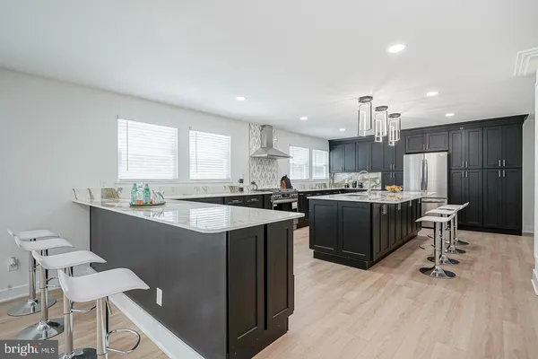 a kitchen with a sink a counter top space a large window and stainless steel appliances