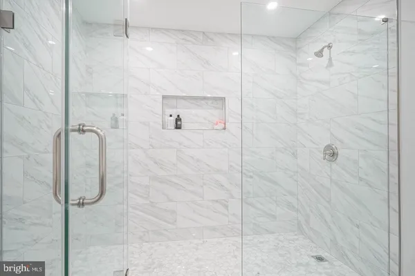 a bathroom with a glass shower door