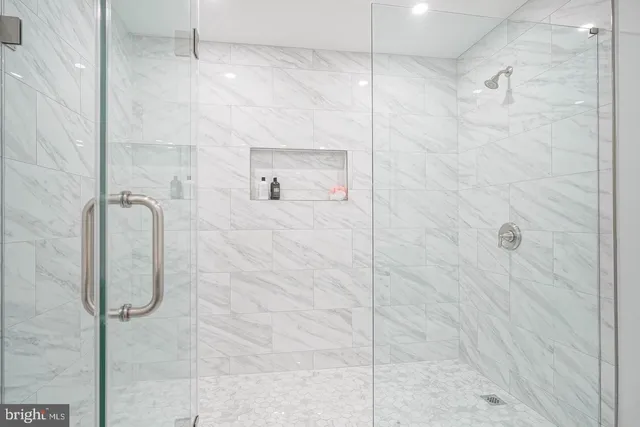 a bathroom with a glass shower door